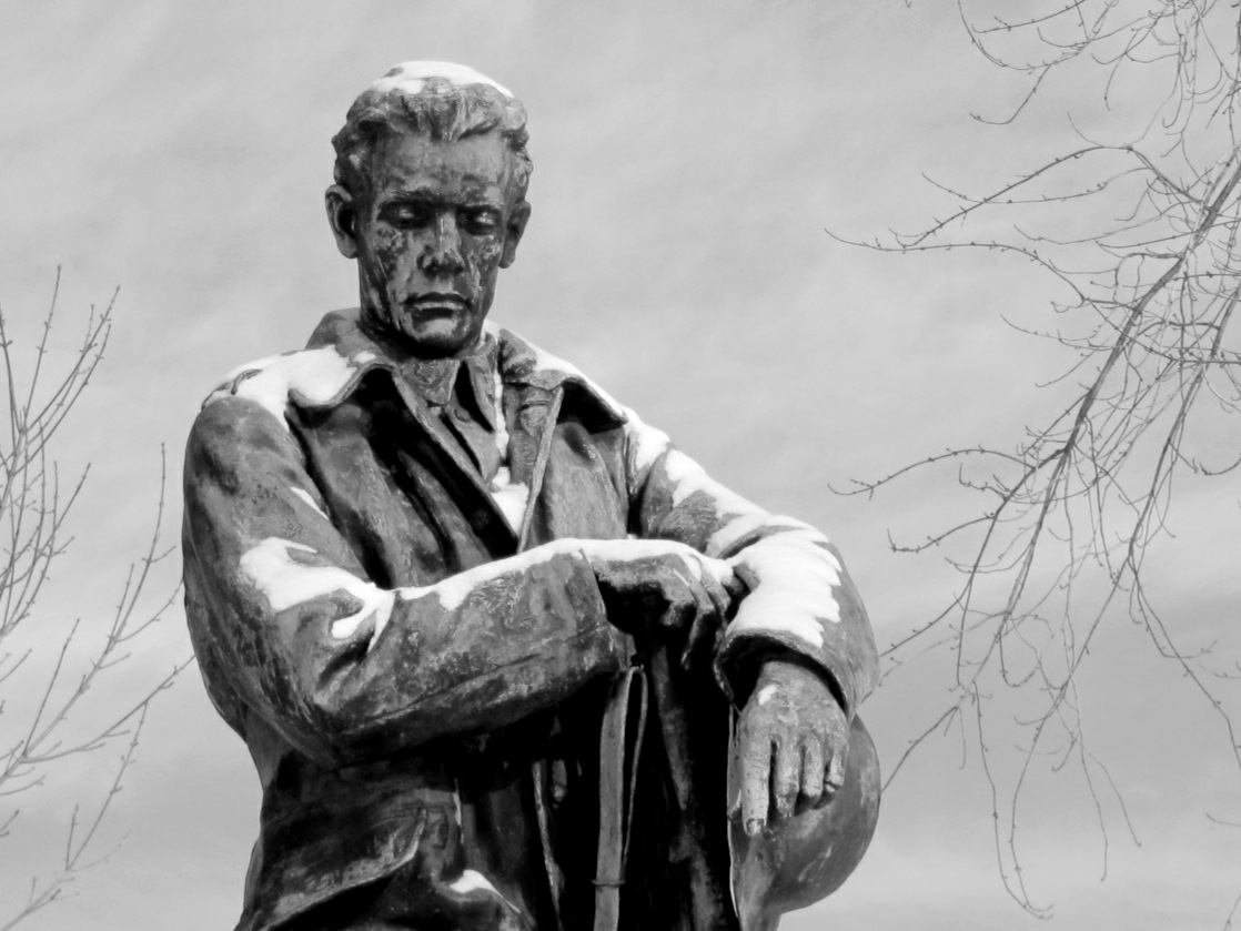 a statue in front of a black and white po
