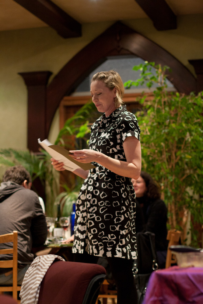 a woman is standing in the middle of a room with her name on paper