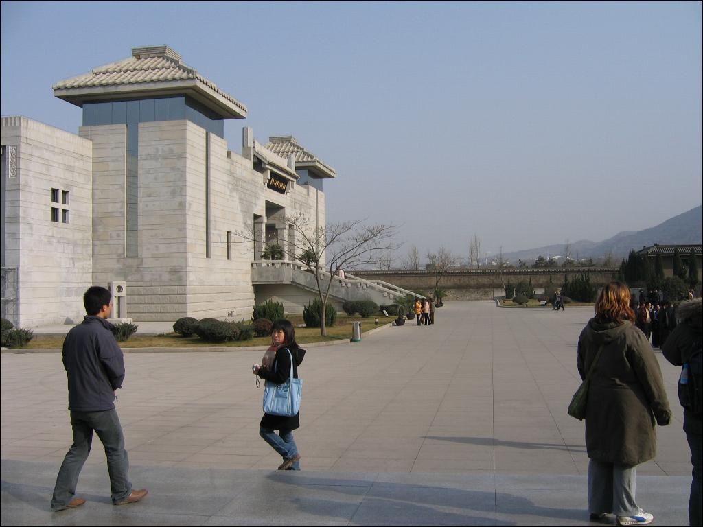 a person walking in front of a building with people