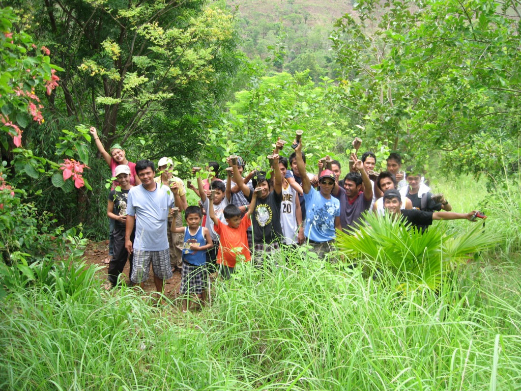 a group of people standing next to each other on a forest floor