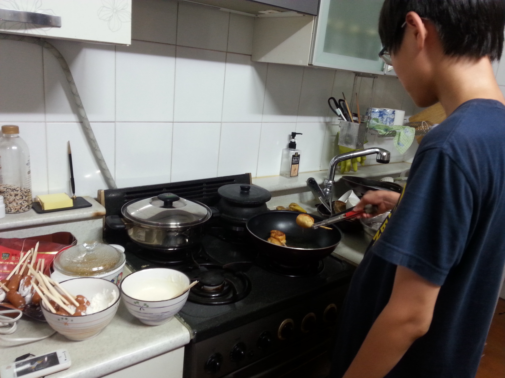 a man standing in a kitchen preparing food