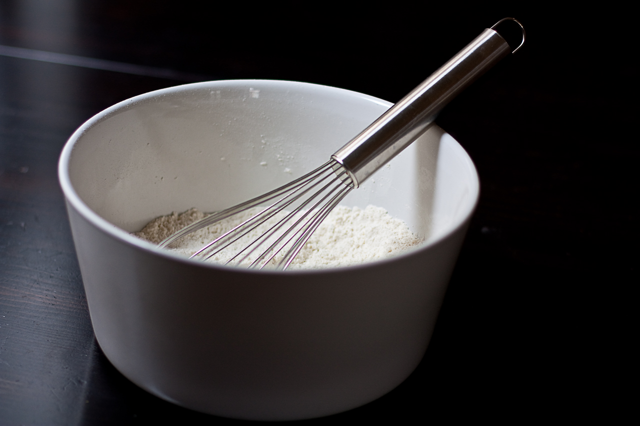 a bowl with a whisk in it, and another whisk that is sitting in it