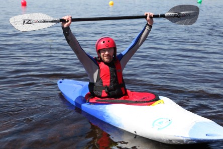 a person wearing a helmet is in a kayak in the water