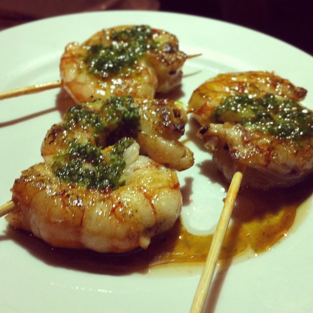 the shrimp is cooked with parsley and is sitting on a plate