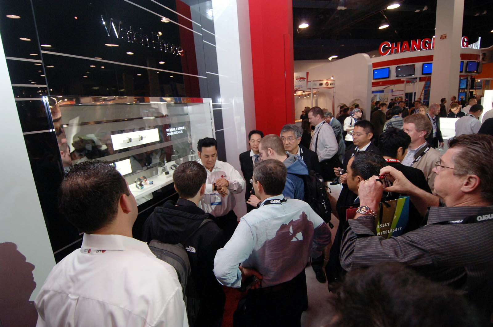 several people looking at objects displayed on shelves