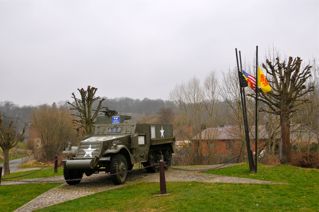 a large army truck parked on the side of a road