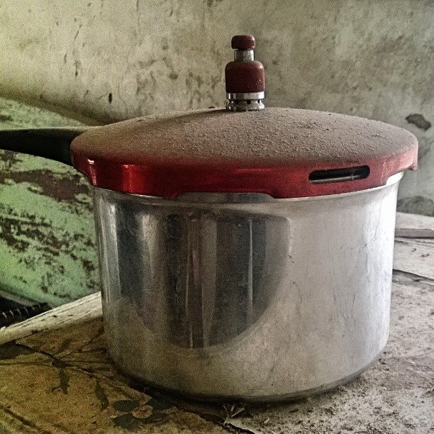 there is a stove that has an open pot on the counter