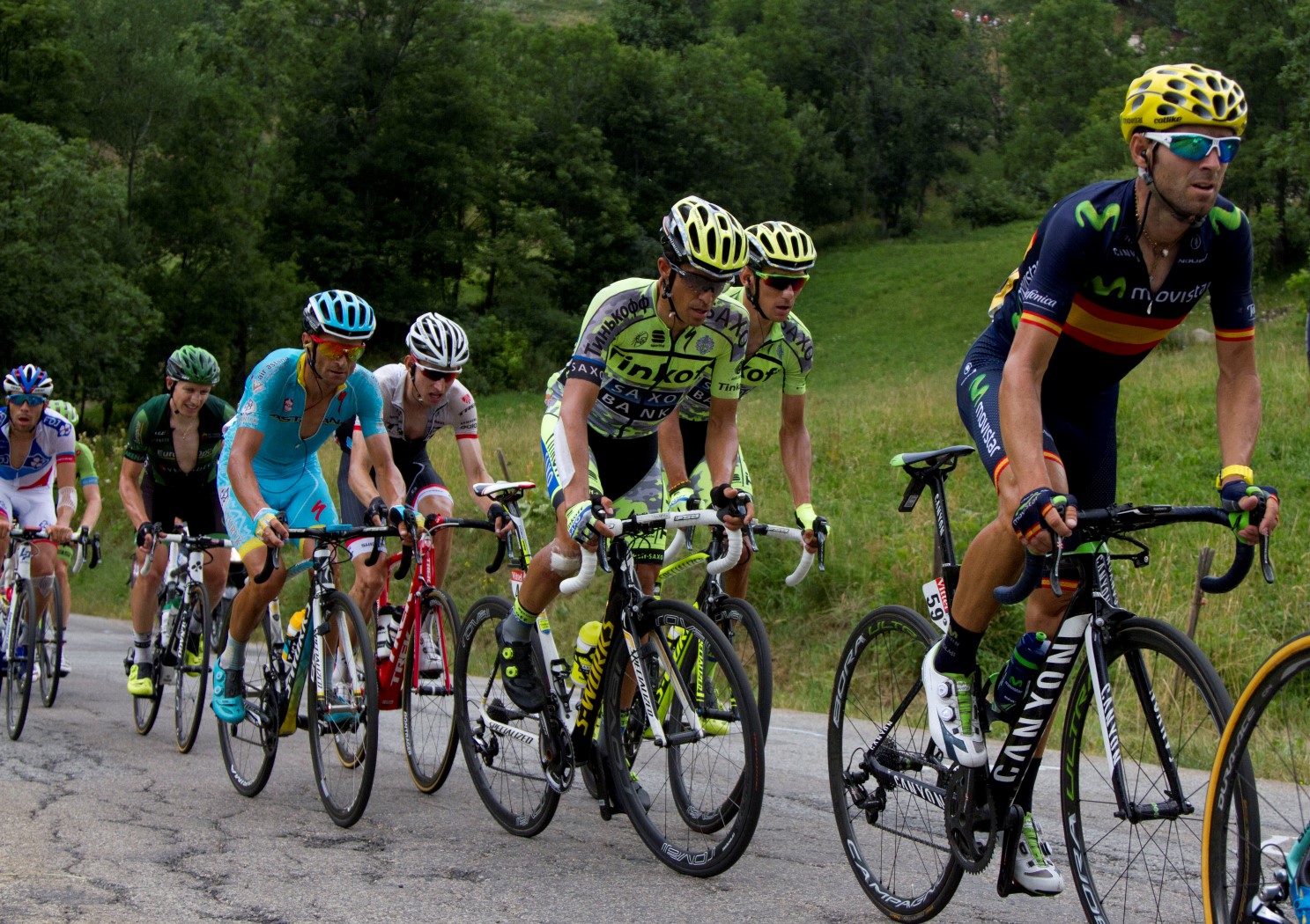 the men are racing their bikes down the road