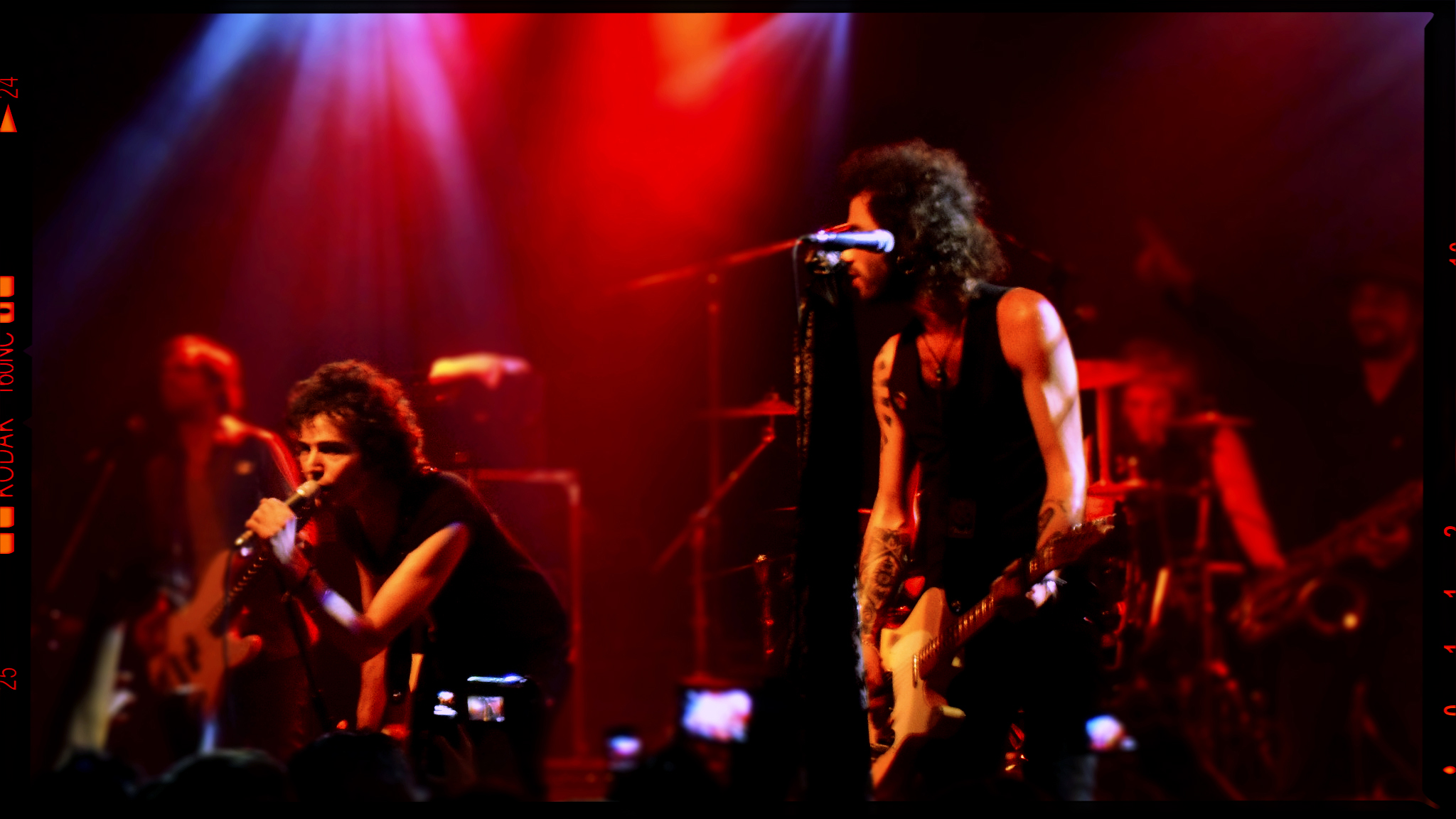 two young people on stage, one of them holding a microphone