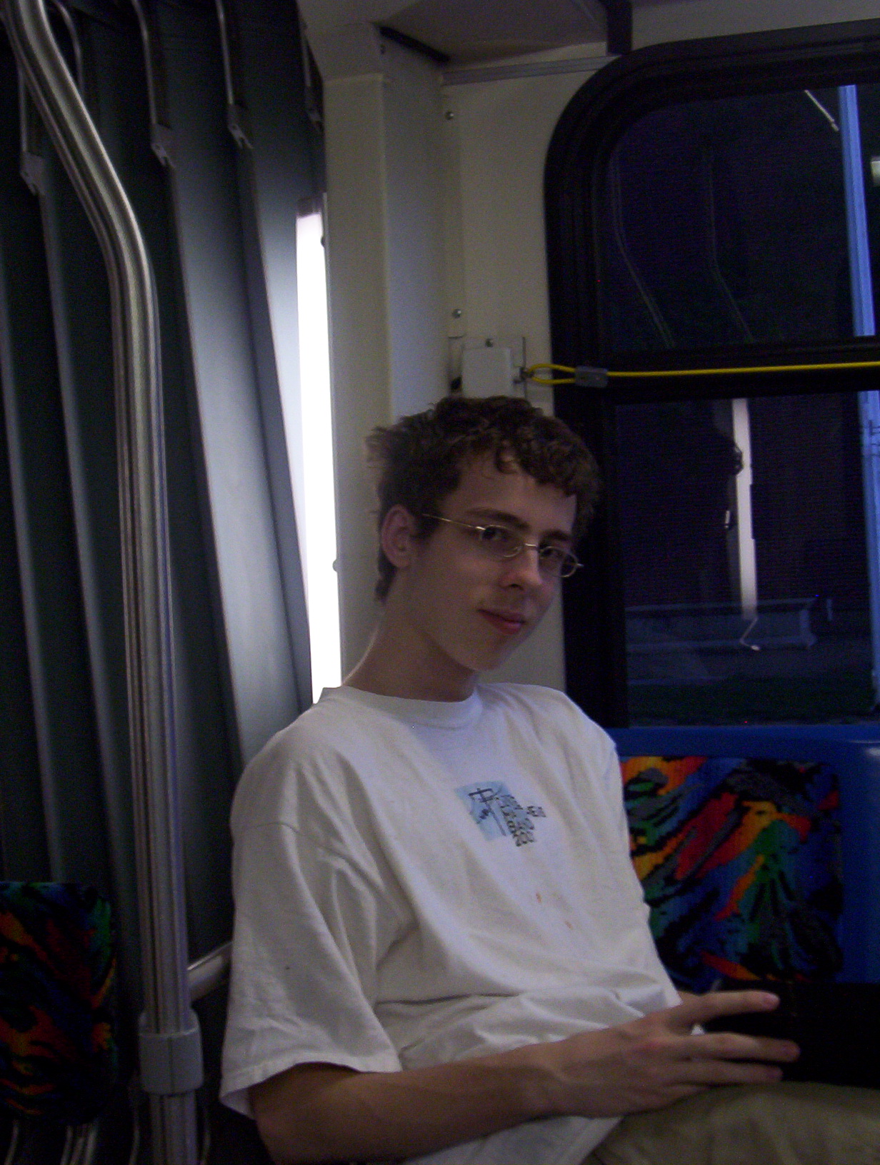 a man in white shirt on a bus