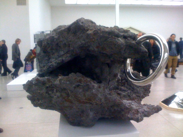 a sculpture made from rocks in a museum