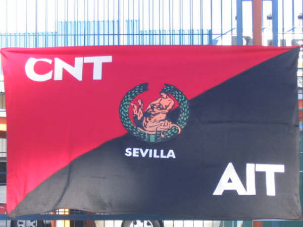 a red and black flag with the emblem of a lion and snake