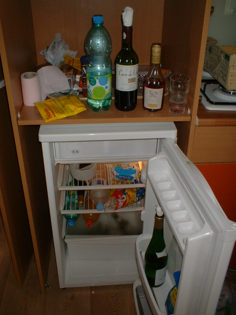 a refrigerator that is open with some stuff on it