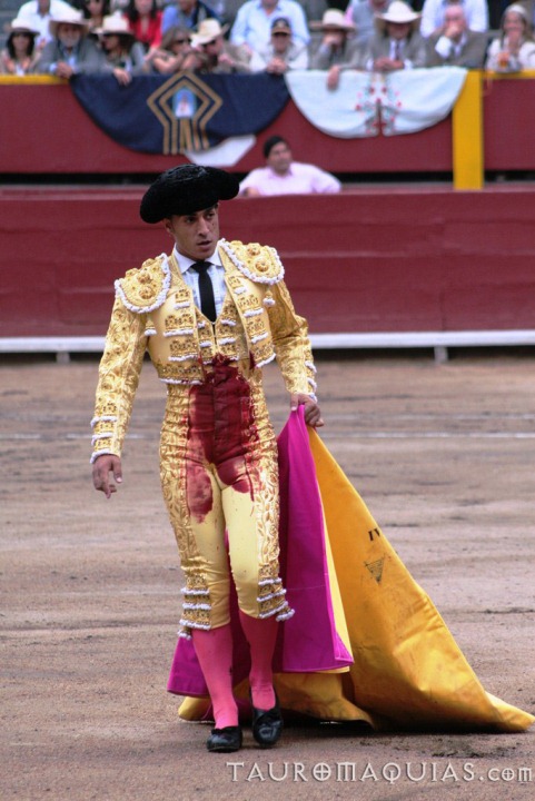 a man in a yellow and pink bull suit