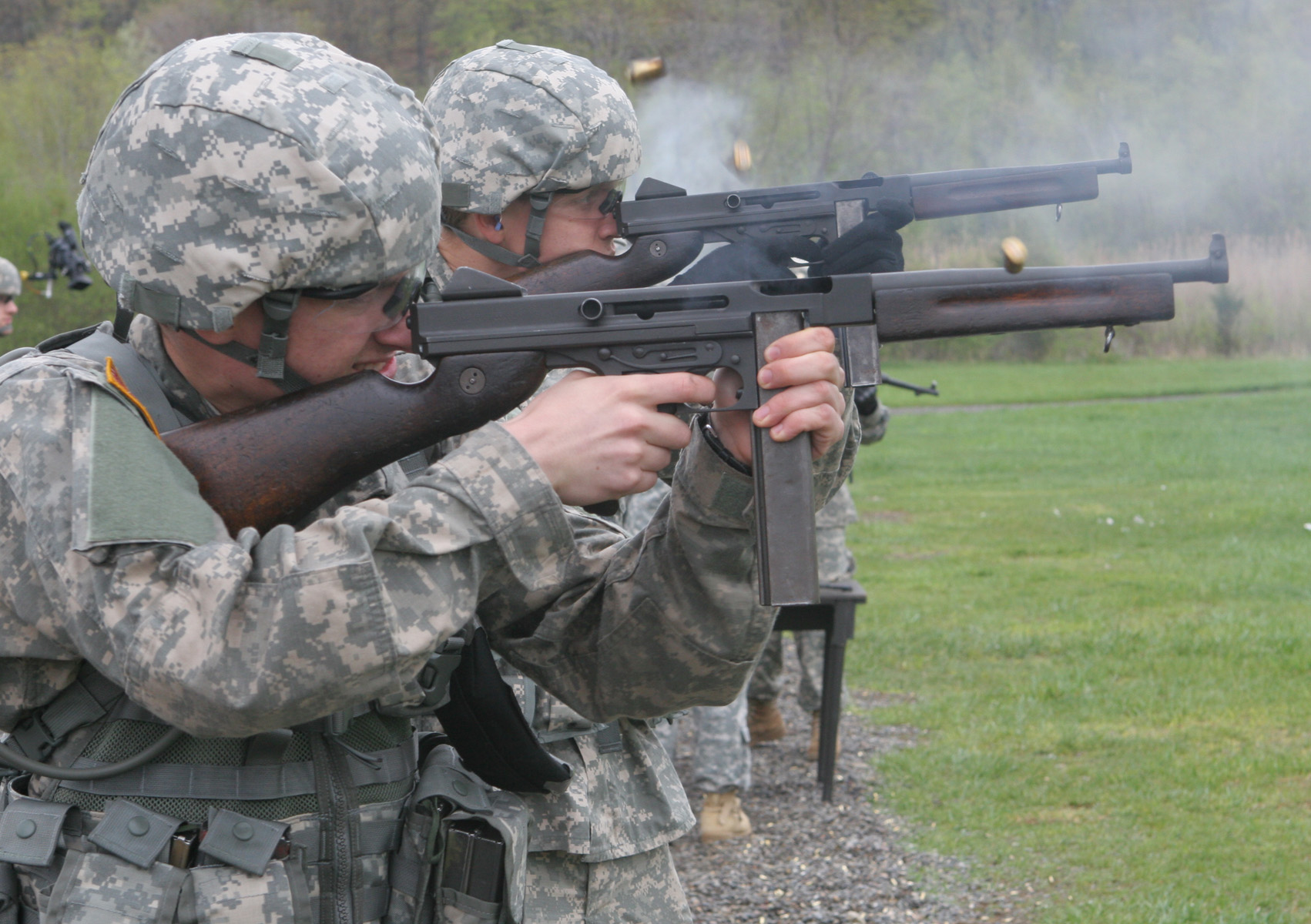 soldiers in uniform aiming guns at targets