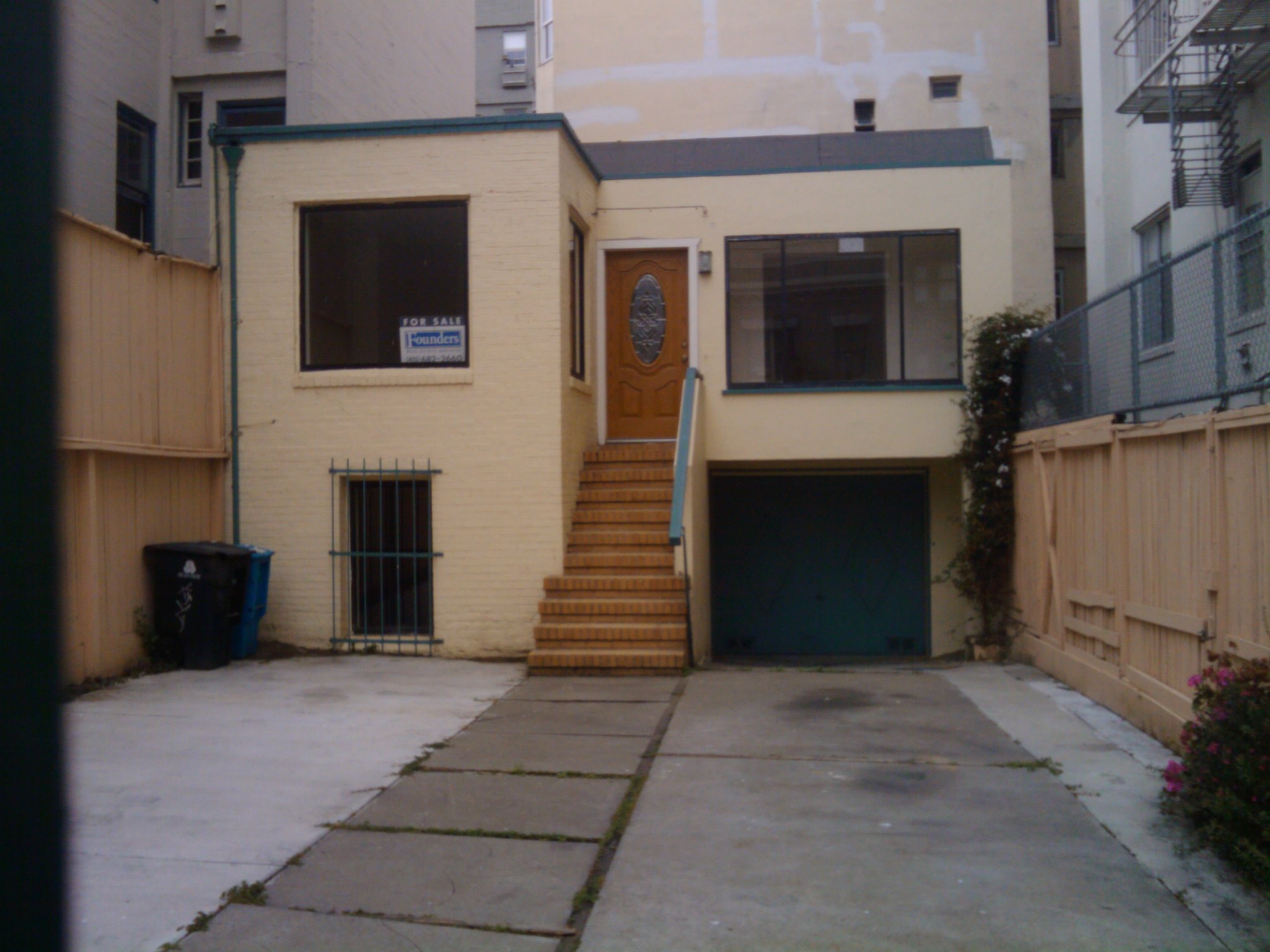 the front entrance of a house with steps to it