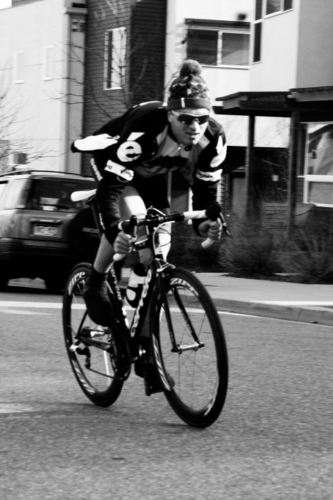 black and white pograph of a person riding a bike