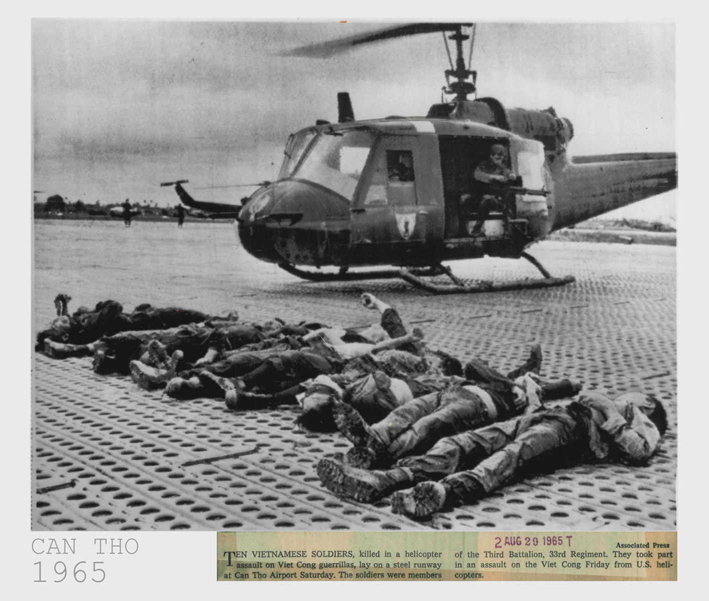 a black and white po of some dead people in front of a helicopter