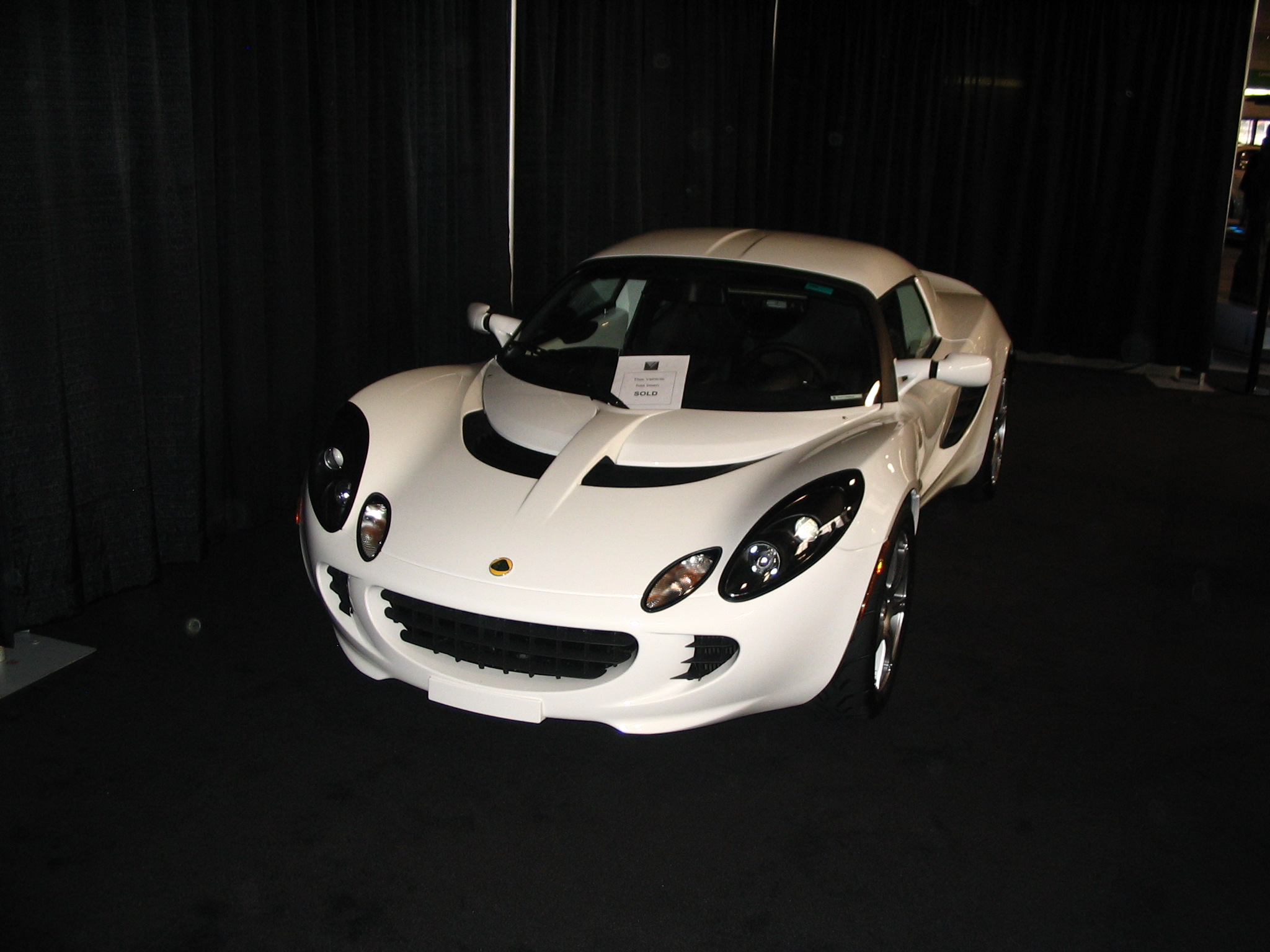 a white sports car in a black room