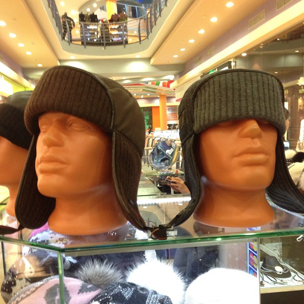 a couple of hats sitting on top of a display