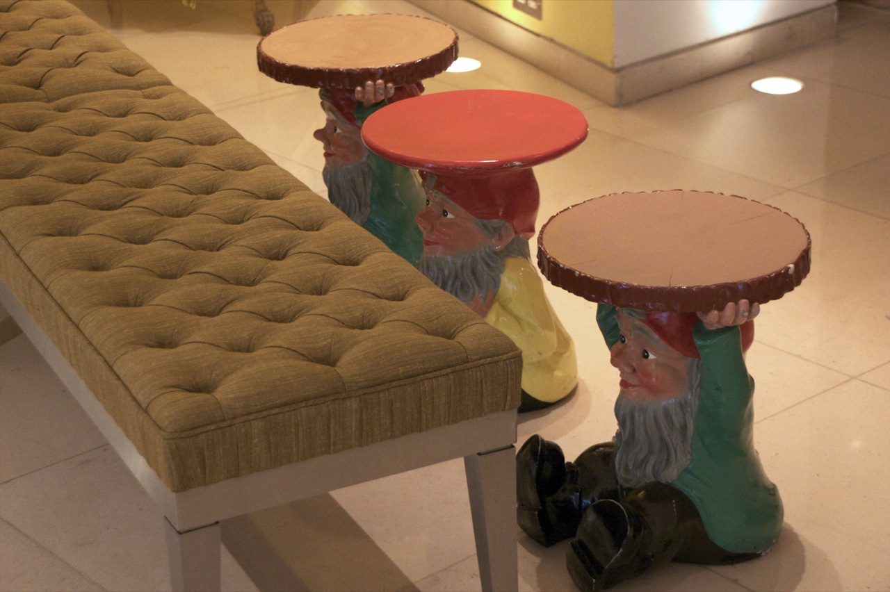 three decorative stools and one bench are sitting in a building