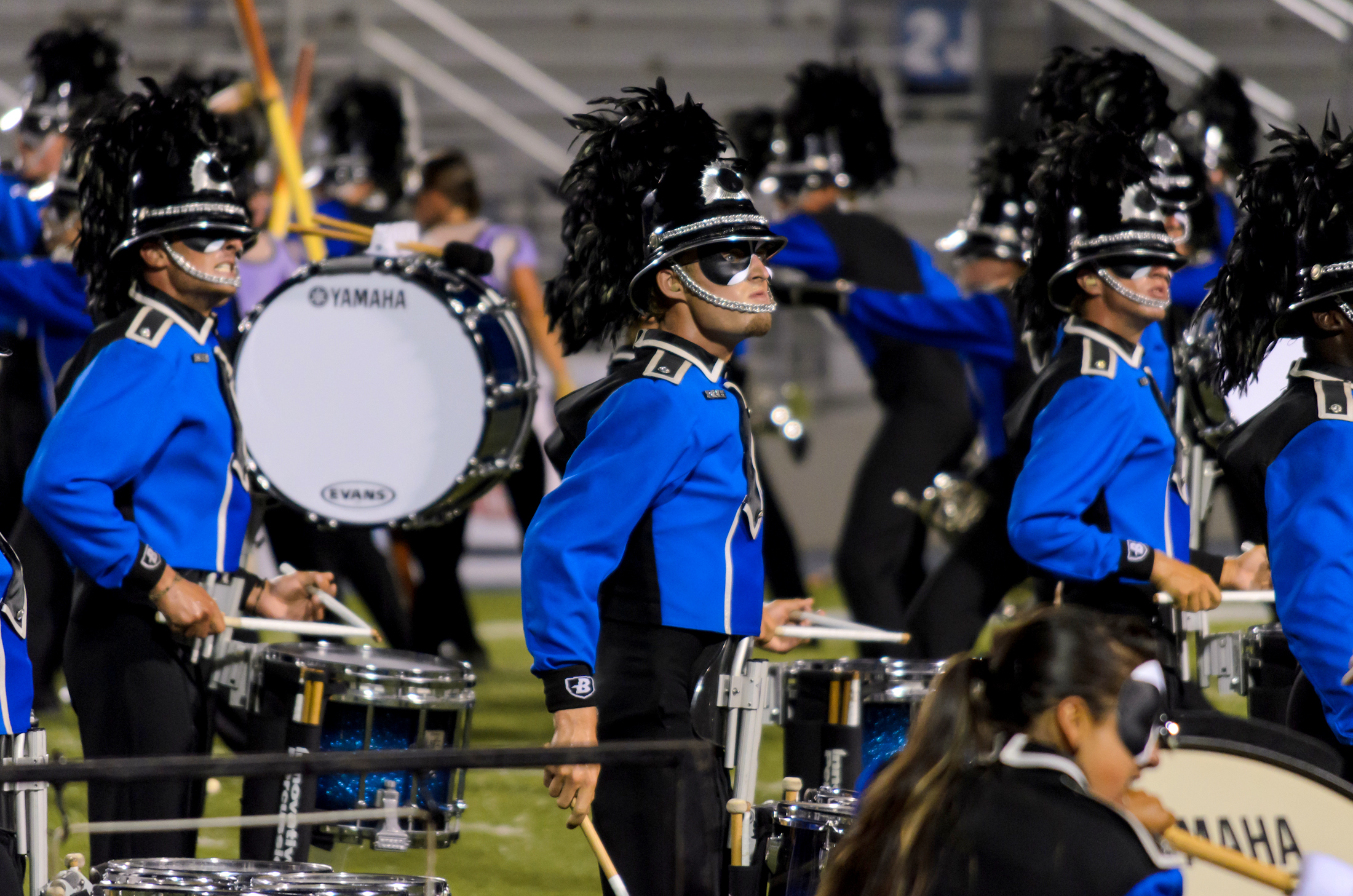 several marching band members in blue outfits