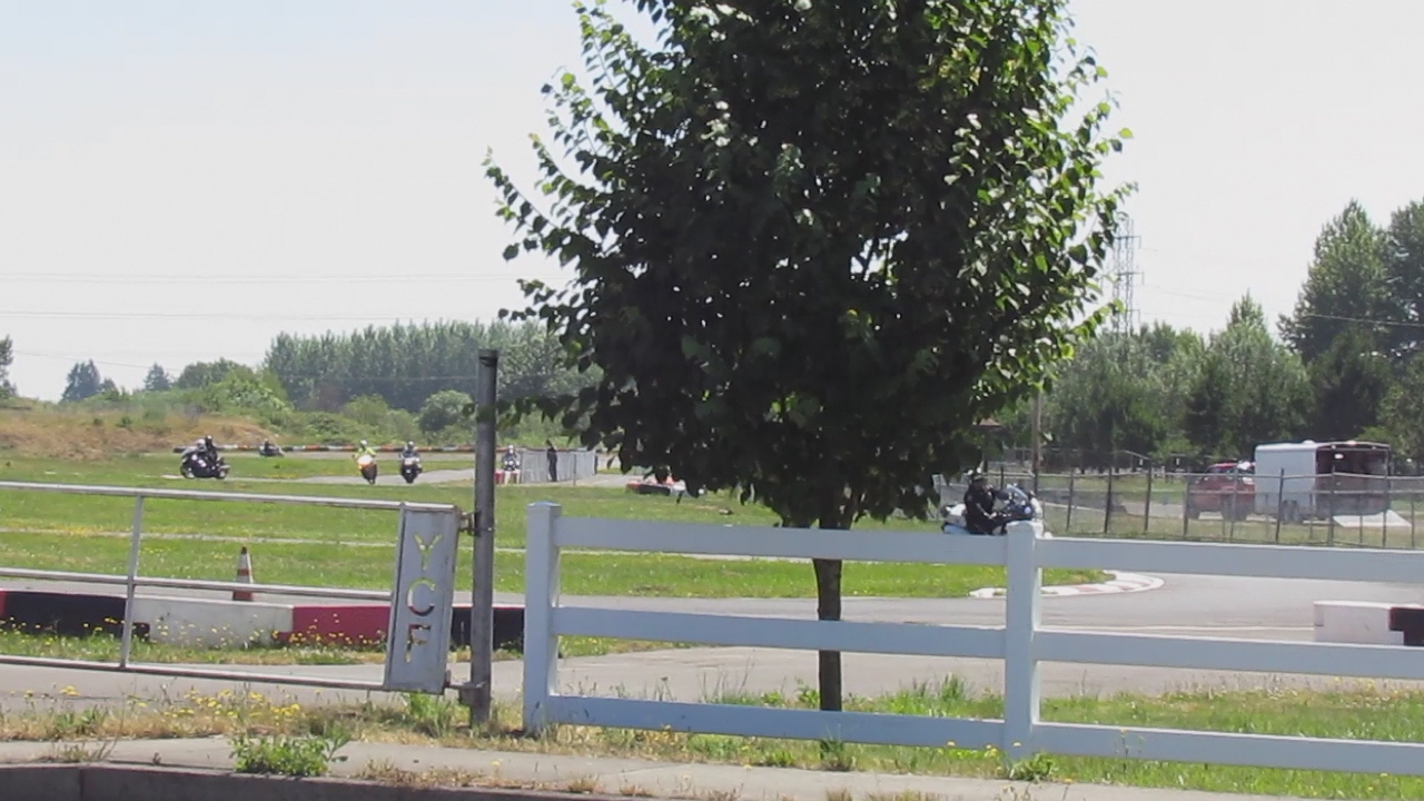 an image of people on motorbikes riding around a track