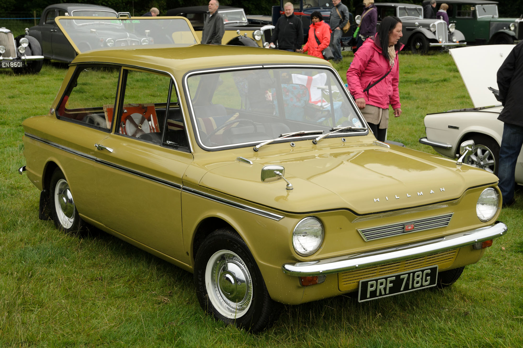 a car with open doors sitting on a lush green field