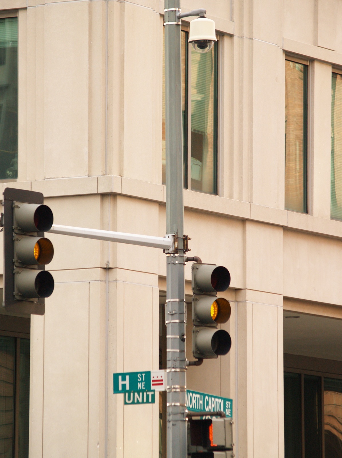 a street light pole with traffic lights attached