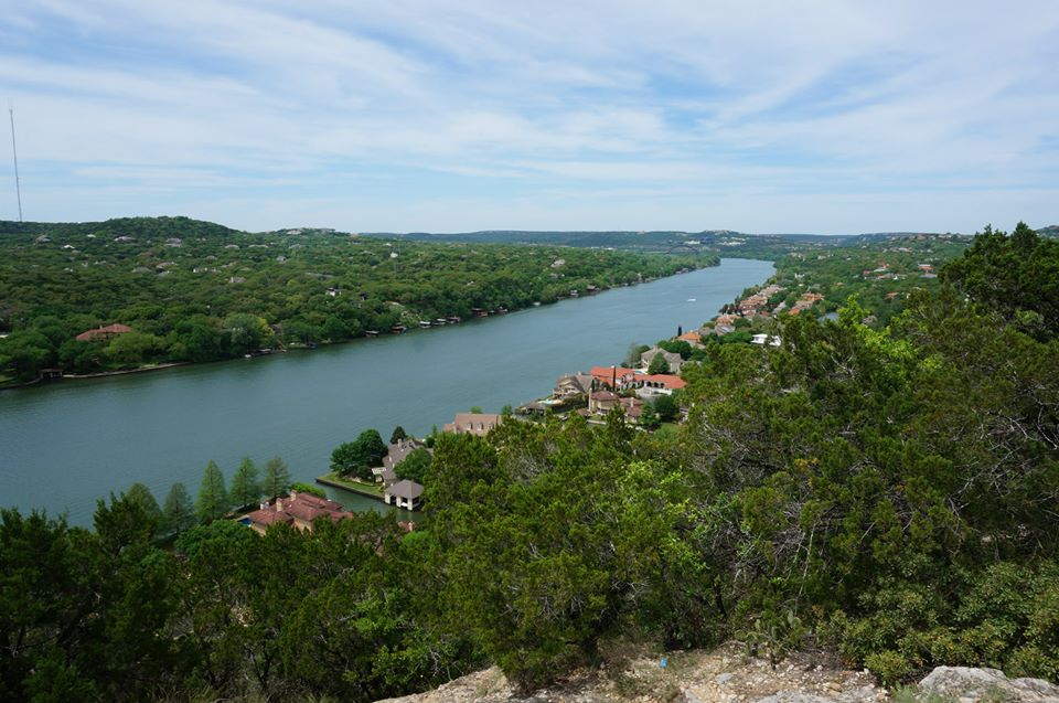 a river runs down a hill next to some trees