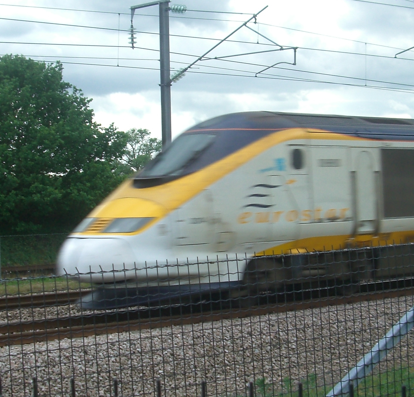 an image of the high speed train speeding on the tracks