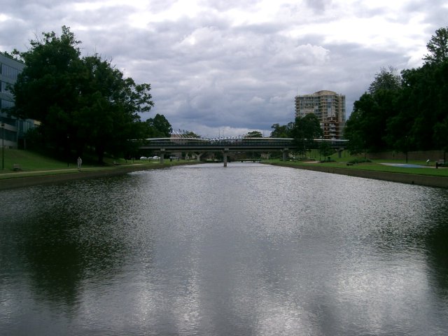 the waterway has water and green bushes along both sides