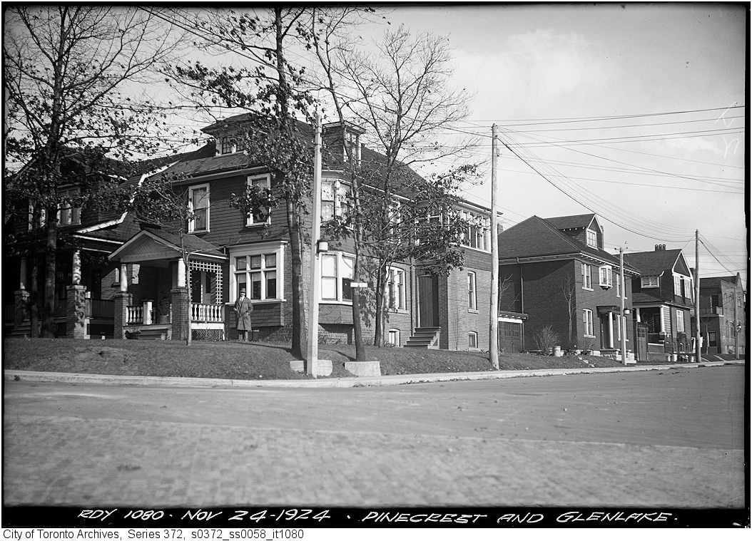 an old - fashioned po shows many older houses on the side of a street