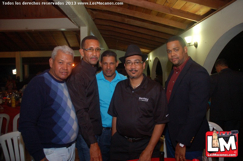 there is a group of men standing around the table