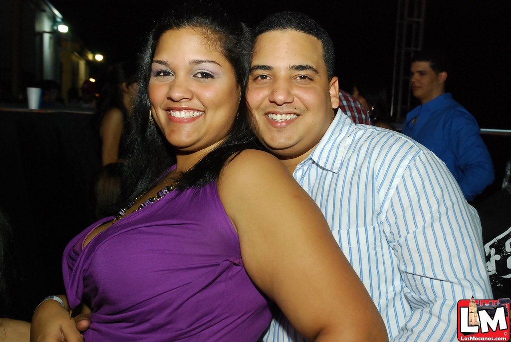 a man and woman smiling for the camera in a party