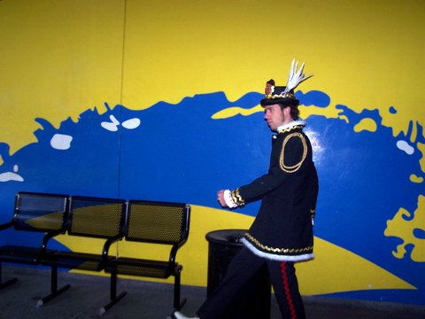 man in a military uniform standing in front of a wall