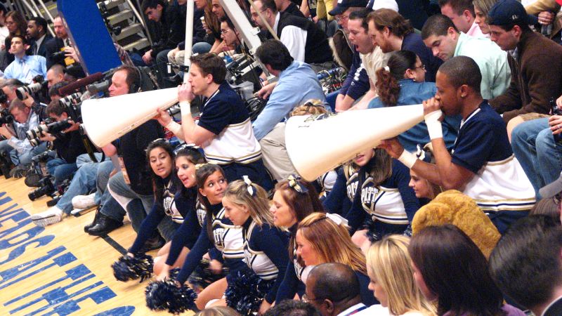 cheerleaders on the sidelines in a gym