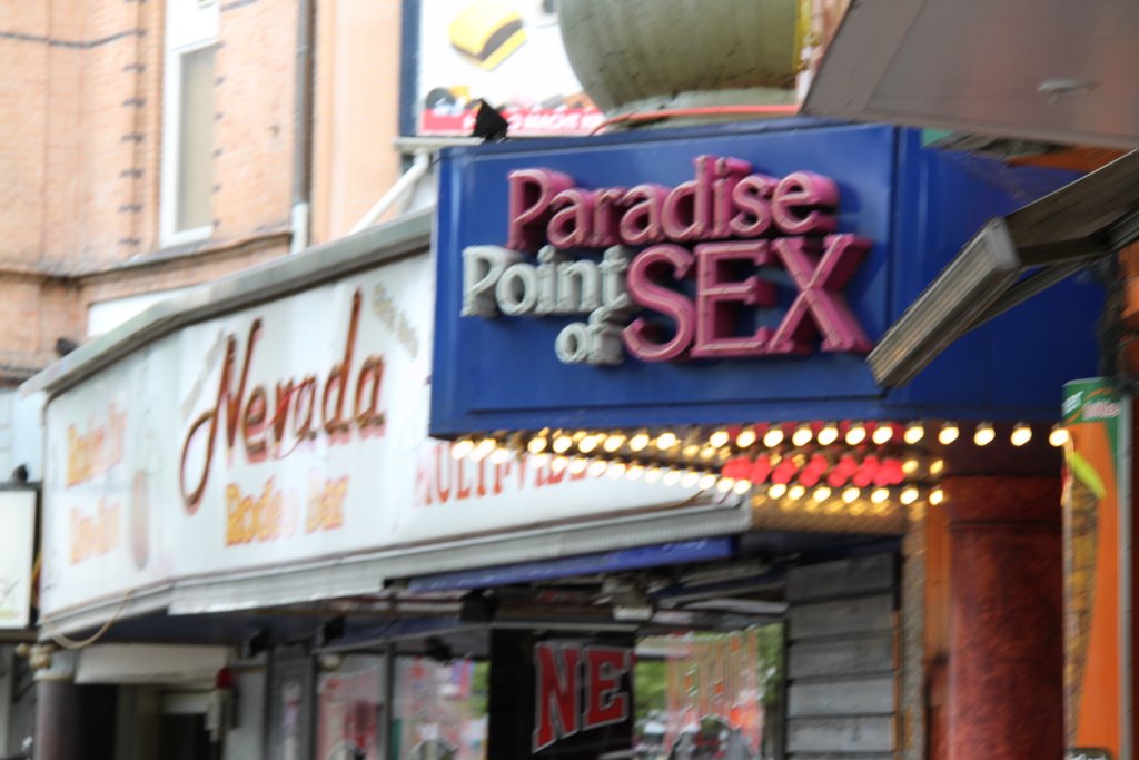 a sex store sign hanging on the side of a building