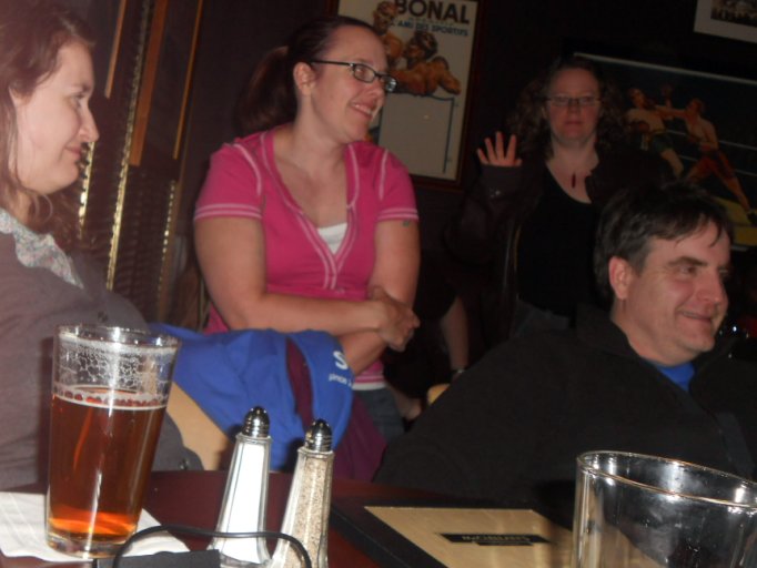 a man sits at a table with his two women