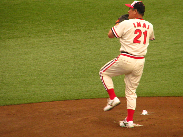 a baseball player pitching a ball from the mound