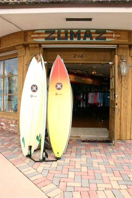 two surfboards are locked up on the side of the building