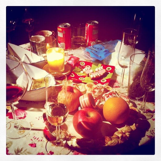 a table topped with glasses of wine and fruit