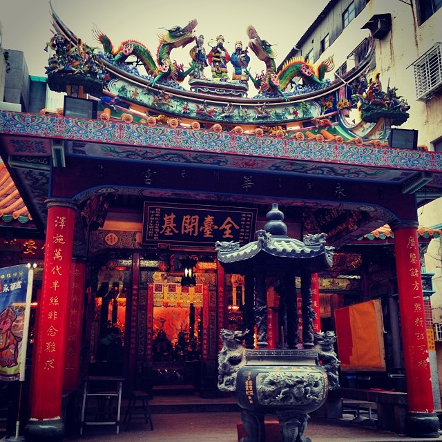 a chinese building with sculptures and oriental writing on it