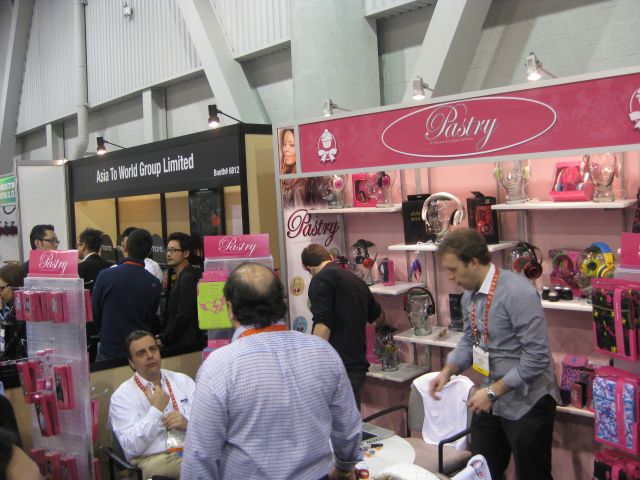 a crowd of people at an exhibition with a display