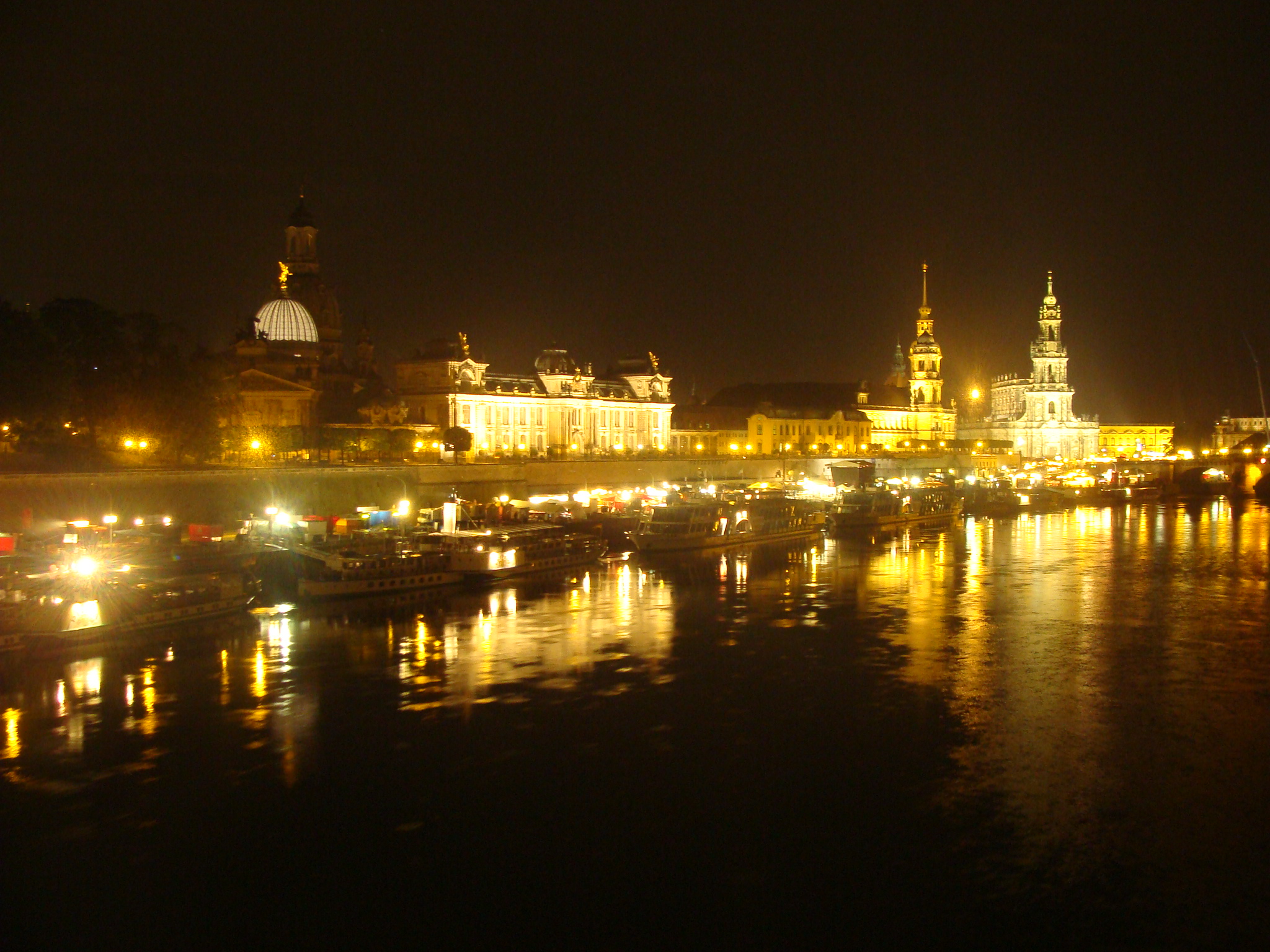 a river at night is lined with buildings