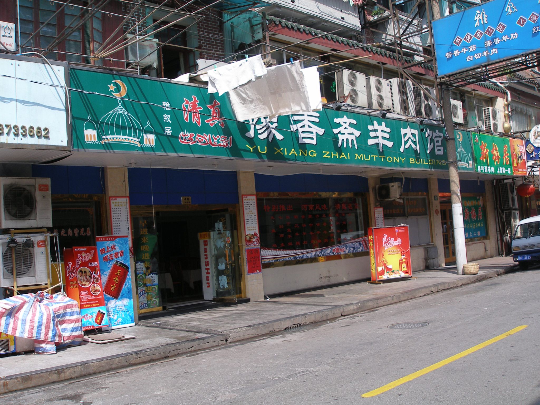 an asian street has a row of shops