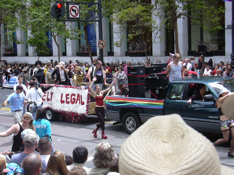 a parade float being followed by a crowd