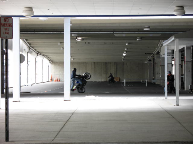 the inside of a parking garage filled with motorcycles