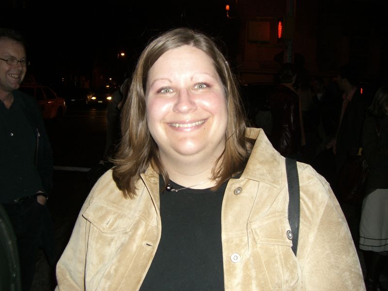 a girl is posing for the camera at night