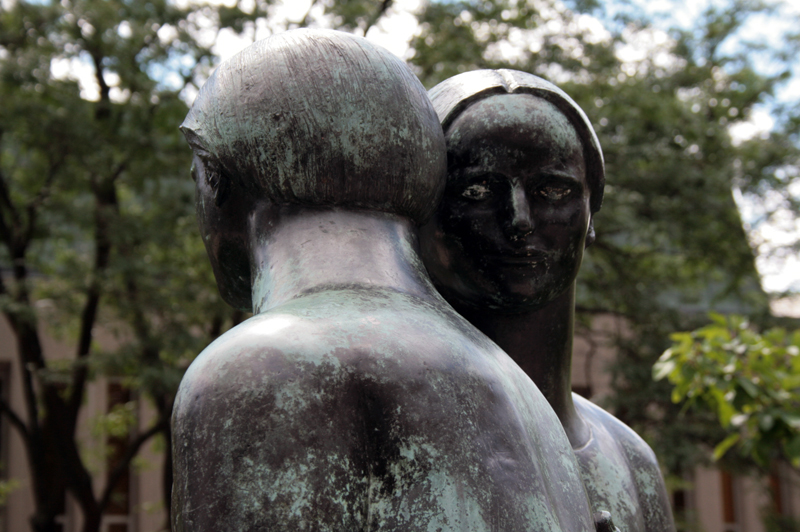 a statue with trees behind it outside